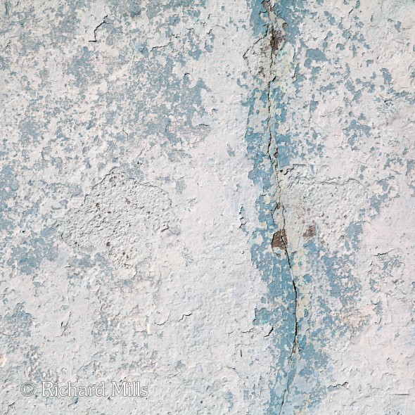 Pale blue painted wall with crack on the island of Burano. A train trip to Venice via London, Paris and Munich in October 2014.